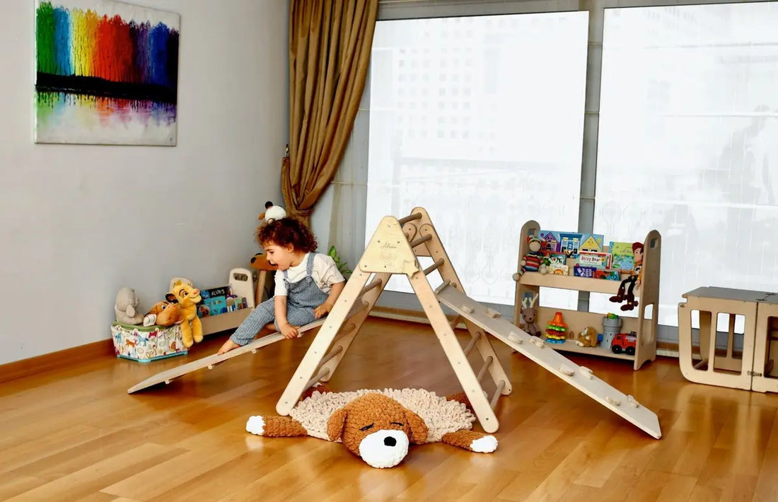 Children's playroom with Montessori climbing structure where a little girl is playing with a teddy bear