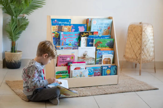 boy reeding book against the background of Montessori Bookshelf