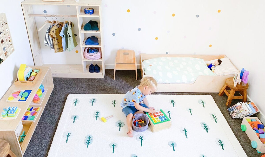 Bright and organized Montessori children's bedroom with a young boy playing with an educational toy on a large rug