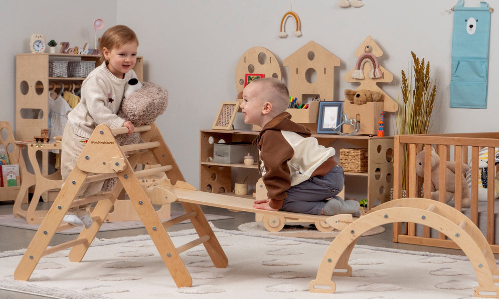 Two small children playing in a Montessori playroom equipped with wooden toys and furniture made from ecological materials